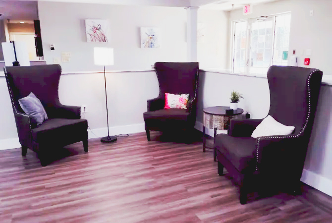 Cozy sitting area with two brown armchairs
